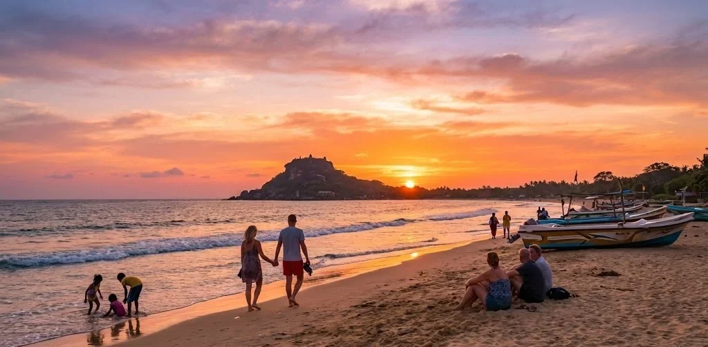 Tourists relaxing on the pristine white sands of Nilaveli Beach, Trincomalee, during a golden sunset with a traditional fishing boat in the background